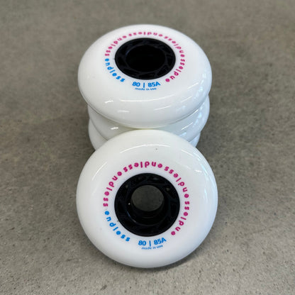 Endless Blading Co. 80 mm white urethane inline skate wheels with black cores and pink and blue branding text