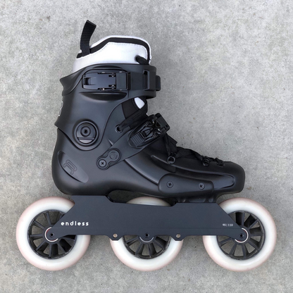 Endless Blading Co. 90 Classic frame in black mounted on a black urban skate boot with three white wheels.