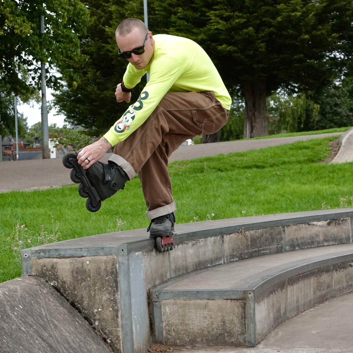 Skater wearing Endless Blading Co. SJR UFS frames performing a soul grind on a concrete ledge at a skate park